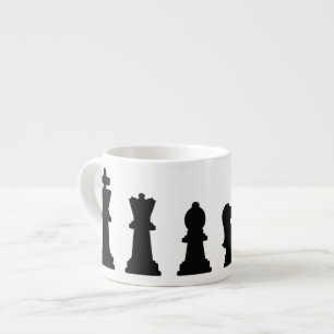 Black chess pieces on white espresso cup