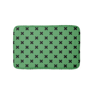 Black cross stitches on green bath mat