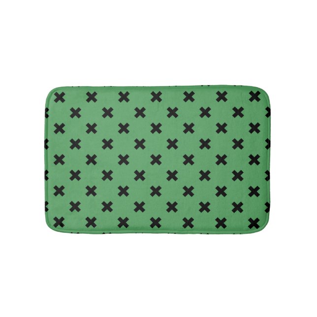 Black cross stitches on green bath mat (Front)