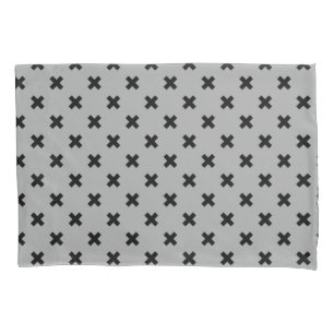 Black cross stitches on grey pillowcase