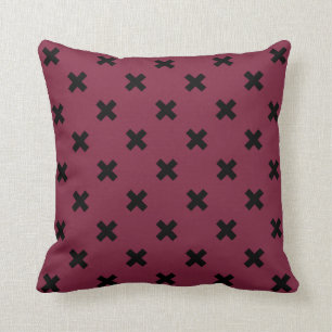Black cross stitches on mulberry cushion