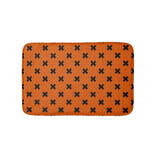 Black cross stitches on orange bath mat