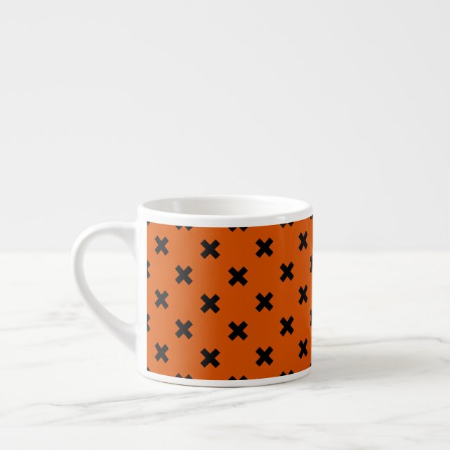 Black cross stitches on orange espresso cup (Left)