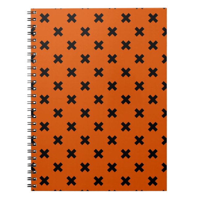 Black cross stitches on orange notebook (Front)