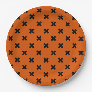Black cross stitches on orange paper plate