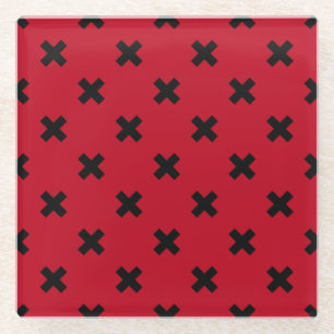 Black cross stitches on red glass coaster