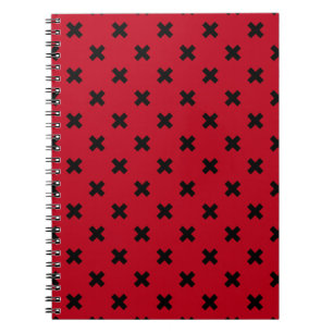 Black cross stitches on red notebook