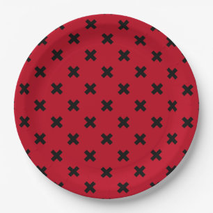 Black cross stitches on red paper plate