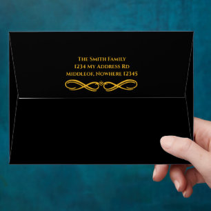 Black envelope with gold interior and address