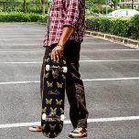 Black gold butterflies pattern name script skateboard<br><div class="desc">A black background decorated with golden butterflies.  Personalise and add your name.</div>