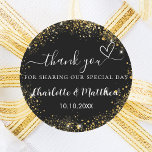 Black gold heart wedding thank you classic round sticker<br><div class="desc">A stylish black background decorated with faux gold glitter,  sparkles.  Personalise and add your names and wedding date. With the text: Thank you for sharing our special day.</div>