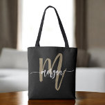 Black Gold Modern Script Girly Monogram Name Tote Bag<br><div class="desc">Make a statement with the Black and Gold Modern Script Girly Monogram Name Tote Bag. Featuring a sleek black canvas with a bold gold monogram in a modern script font, this tote is designed with a girly touch to elevate your everyday style. Spacious and practical, it’s perfect for shopping, work,...</div>