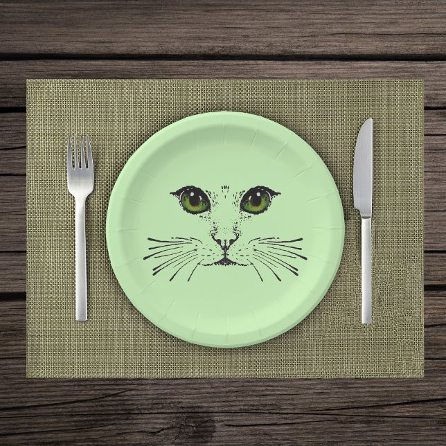black Illustration of Cat Face Green Eyes Whiskers Paper Plate (Illustration in black of cat face with intense green eyes and whiskers on light green paper plate.)