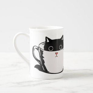 Black kitten with red nose hiding in a cup