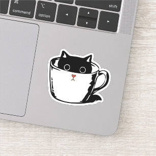 Black kitten with red nose hiding in a cup