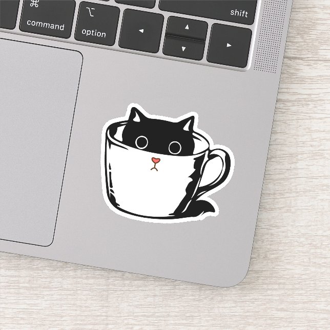 Black kitten with red nose hiding in a cup (Detail)