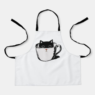 Black kitten with red nose hiding in a cup apron