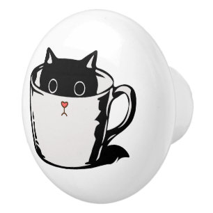 Black kitten with red nose hiding in a cup ceramic knob