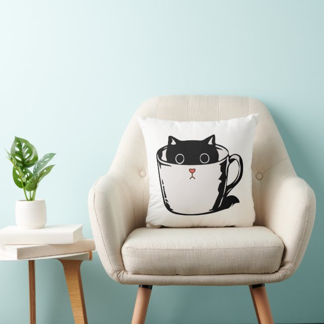 Black kitten with red nose hiding in a cup cushion (Chair)