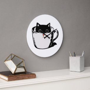 Black kitten with red nose hiding in a cup large clock