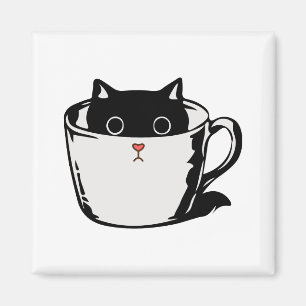 Black kitten with red nose hiding in a cup magnet