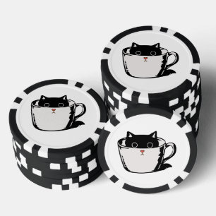 Black kitten with red nose hiding in a cup poker chips