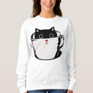 Black kitten with red nose hiding in a cup sweatshirt