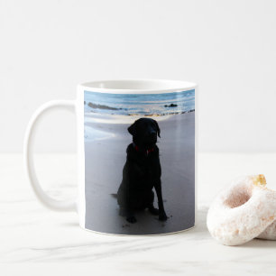 Black Labrador on a beach Coffee Mug