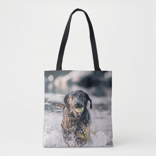 Black Labrador Plays Fetch In Water Tote Bag (Front)