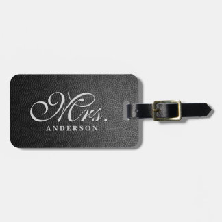 Black leather background monogrammed luggage tag