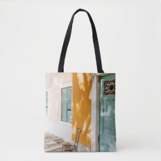 Black metal chair near dor tote bag