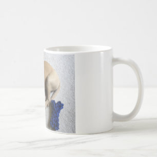 Black-mouth cur puppy with blue toy coffee mug