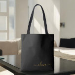 Black Name Gold Girly Script Monogram Modern Tote Bag<br><div class="desc">Black and Gold Elegant Add Your Own Name Monogram Book Bag. This Book Bag can be customised to include your initial and first name and given as a gift for Christmas,  Sweet 16 Birthday,  Bridal Shower or a Wedding.</div>