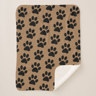 black paw prints on brown sherpa blanket
