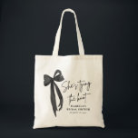 Black Pink Bow She's Tying the Knot Bridal Shower  Tote Bag<br><div class="desc">Add a stylish touch to your bridal shower with our Black Pink Bow She's Tying the Knot Bridal Shower Tote Bag! Featuring a chic black design with a feminine pink bow, this tote bag is perfect for carrying favours, gifts, or essentials for the special day. It's an elegant and practical...</div>