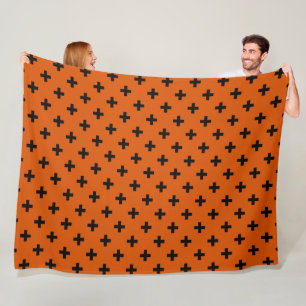 Black polka crosses on orange fleece blanket