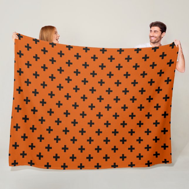 Black polka crosses on orange fleece blanket (In Situ)
