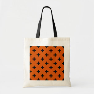 Black polka crosses on orange tote bag