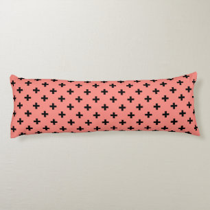 Black polka crosses on peach body cushion