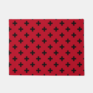 Black polka crosses on red doormat
