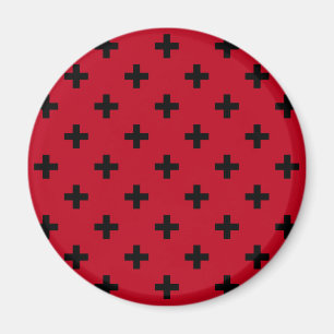 Black polka crosses on red magnet