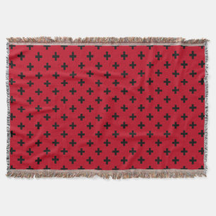 Black polka crosses on red throw blanket