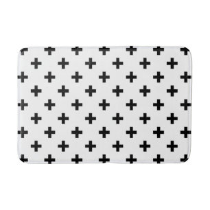 Black polka crosses on white bath mat