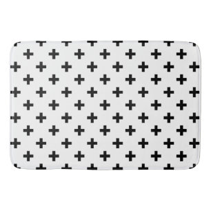 Black polka crosses on white bath mat