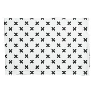 Black polka crosses on white pillowcase