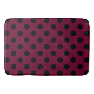 Black polka dots on burgundy bath mat
