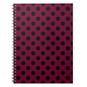 Black polka dots on burgundy notebook