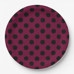 Black polka dots on burgundy paper plate