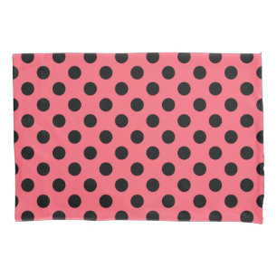 Black polka dots on coral pillowcase