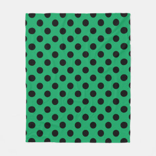 Black polka dots on fresh green fleece blanket